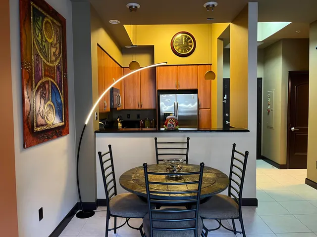 a living room with a couch and a dining table