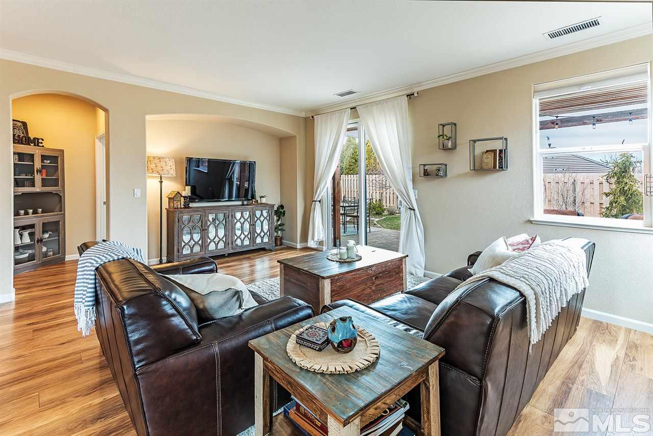 395 Sondrio Way Reno, NV 89521 - Photo 11 of 25 a living room with fireplace furniture and a wooden floor