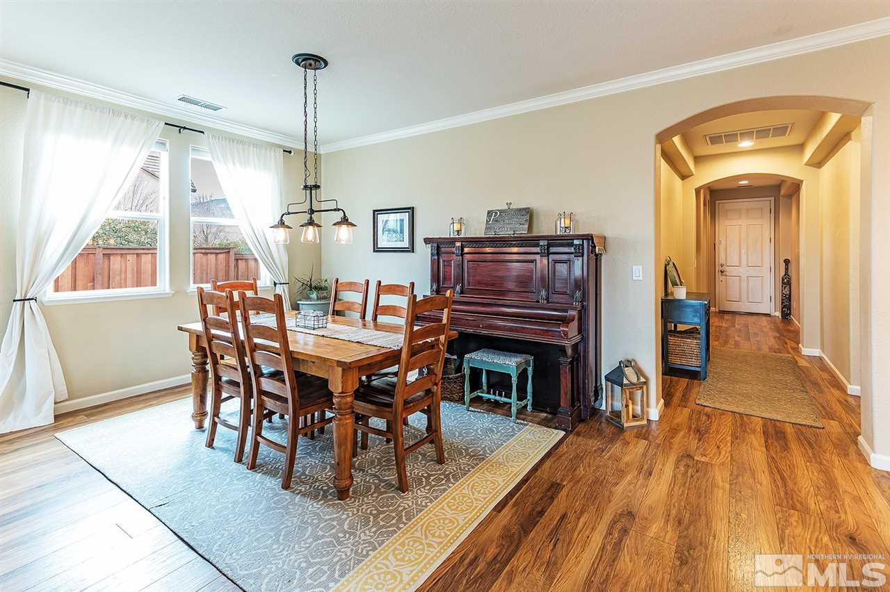 395 Sondrio Way Reno, NV 89521 - Photo 12 of 25 a dining room with furniture a chandelier and wooden floor
