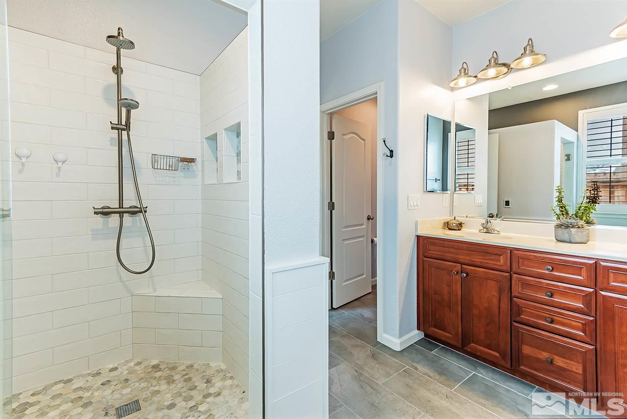 395 Sondrio Way Reno, NV 89521 - Photo 14 of 25 a bathroom with a shower sink and mirror
