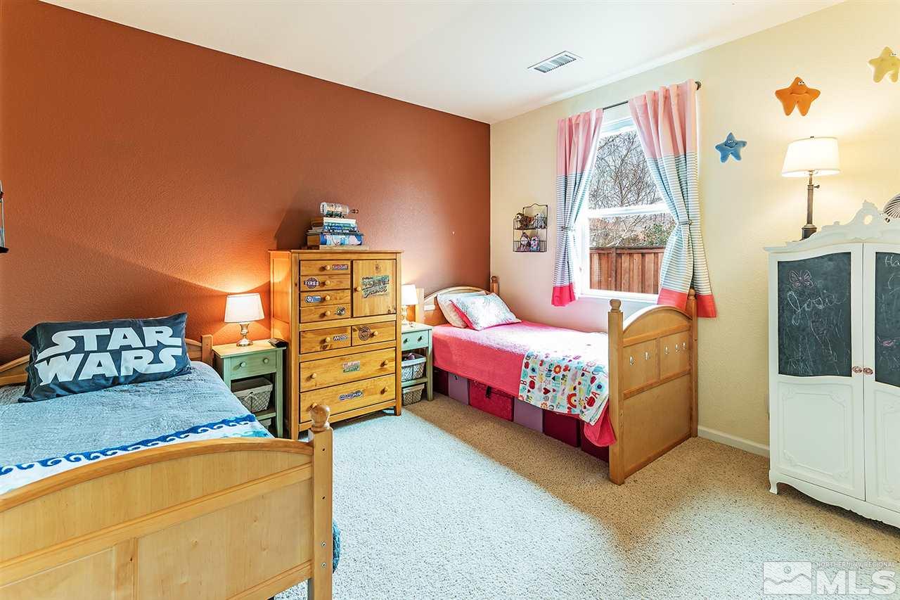 395 Sondrio Way Reno, NV 89521 - Photo 17 of 25 a bedroom with a bed and a window