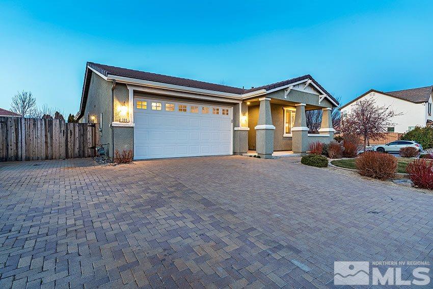 395 Sondrio Way Reno, NV 89521 - Photo 2 of 25 a front view of a house with a yard and garage