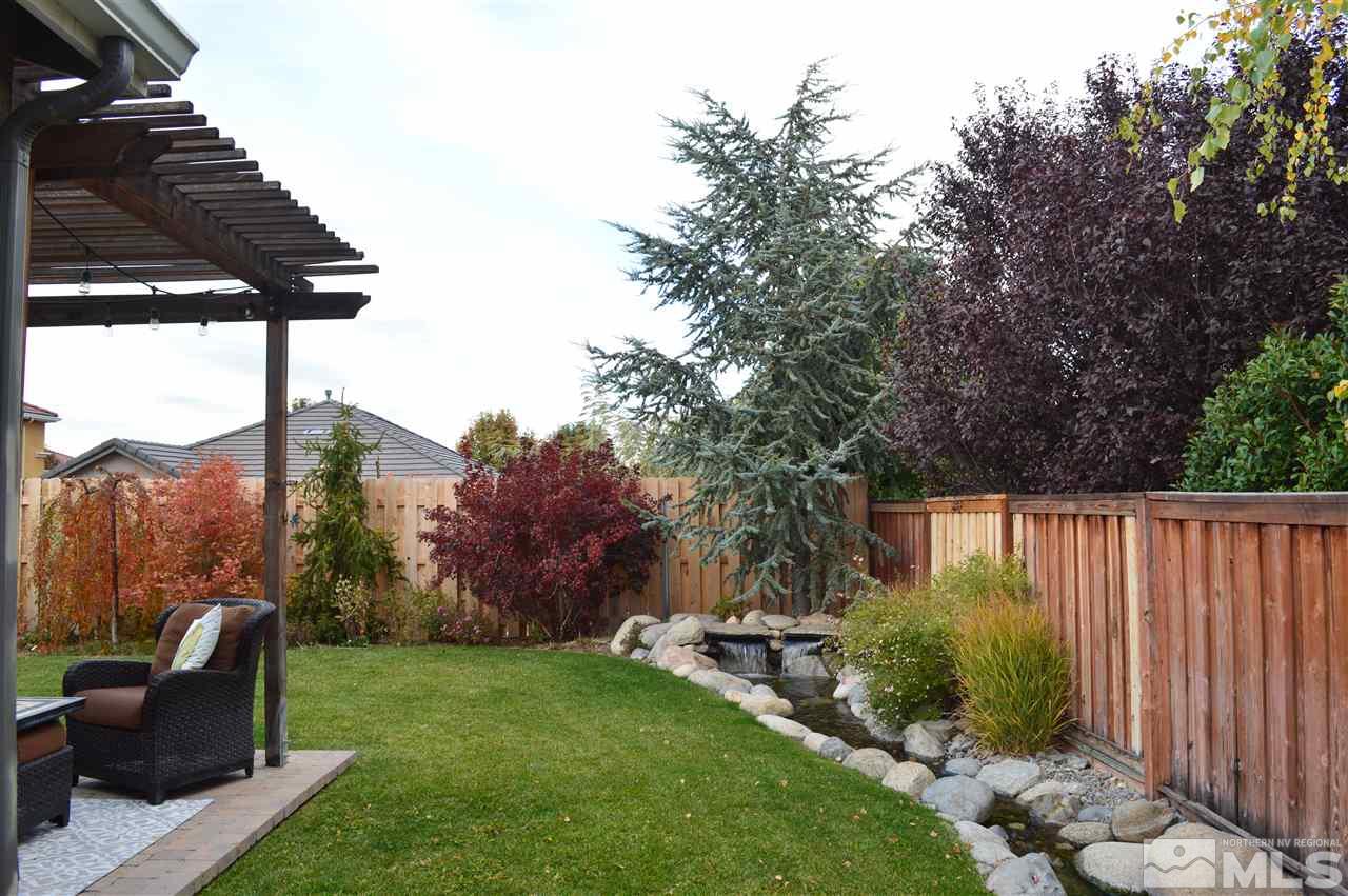 395 Sondrio Way Reno, NV 89521 - Photo 23 of 25 a view of backyard with seating space and trees
