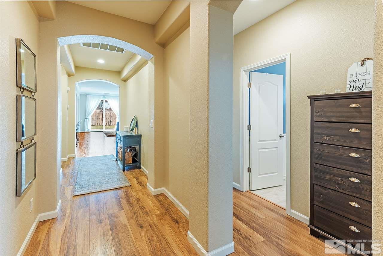 395 Sondrio Way Reno, NV 89521 - Photo 4 of 25 a view of a hallway view with wooden floor and living room