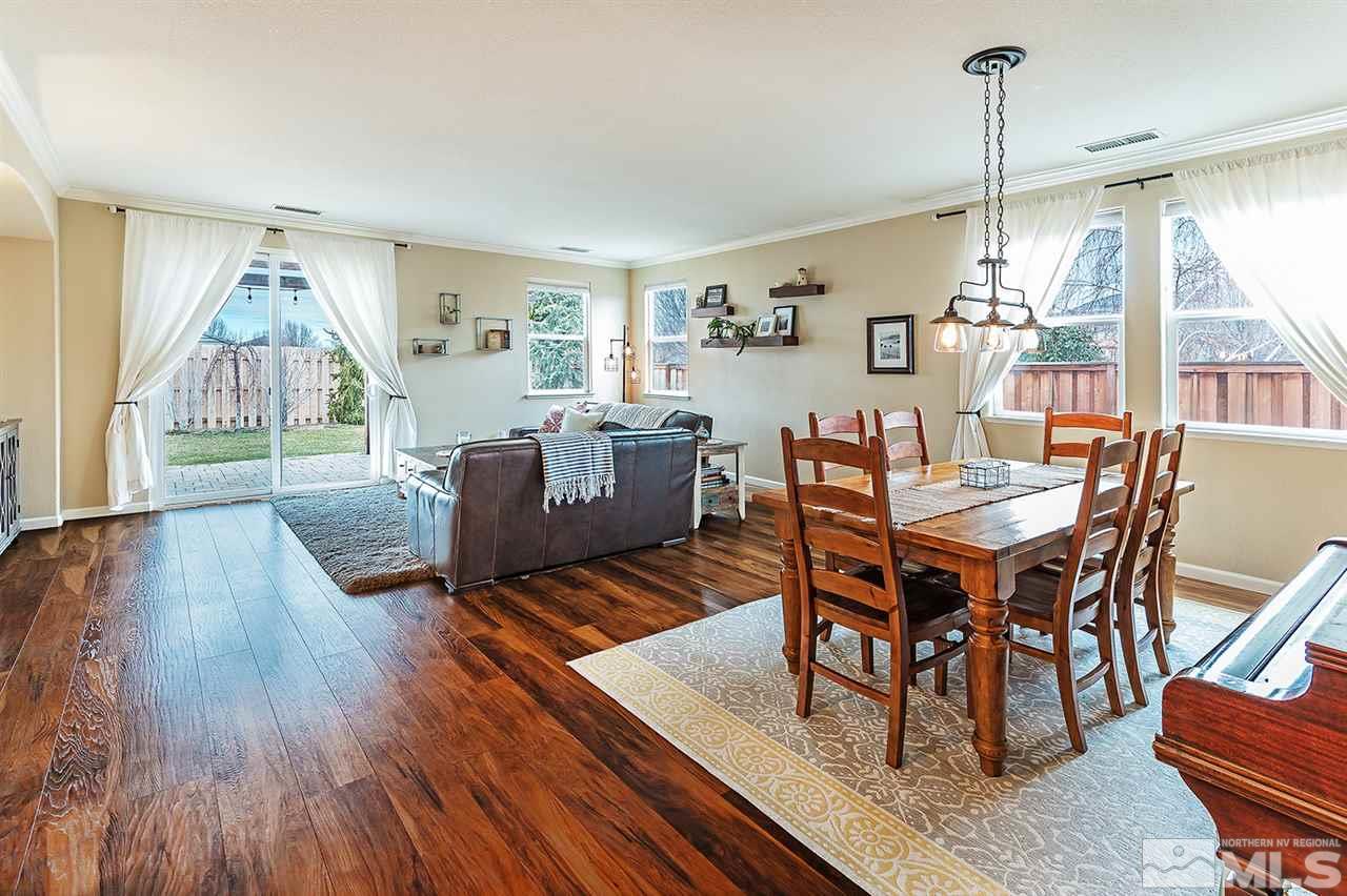 395 Sondrio Way Reno, NV 89521 - Photo 5 of 25 a view of a dining room with furniture wooden floor and chandelier