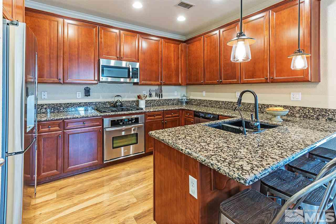 395 Sondrio Way Reno, NV 89521 - Photo 6 of 25 a kitchen with a sink stove top oven and microwave