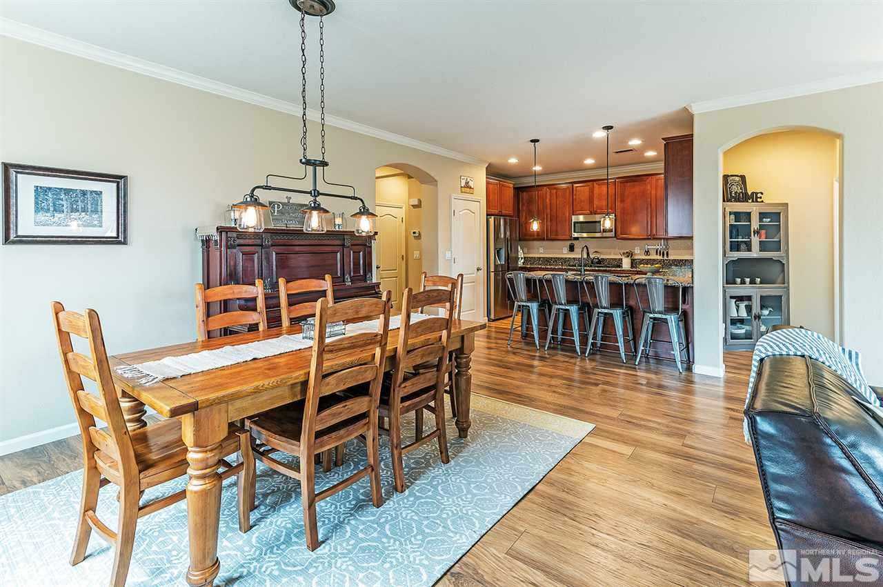395 Sondrio Way Reno, NV 89521 - Photo 7 of 25 a dining room with furniture a chandelier and wooden floor