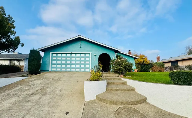 a front view of a house with garden