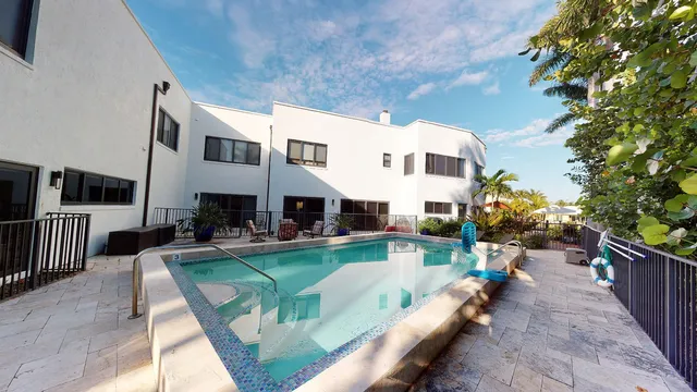 a view of a lake with boats and palm trees