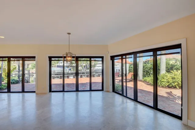 a kitchen with stainless steel appliances granite countertop a refrigerator a stove and a sink with wooden floor