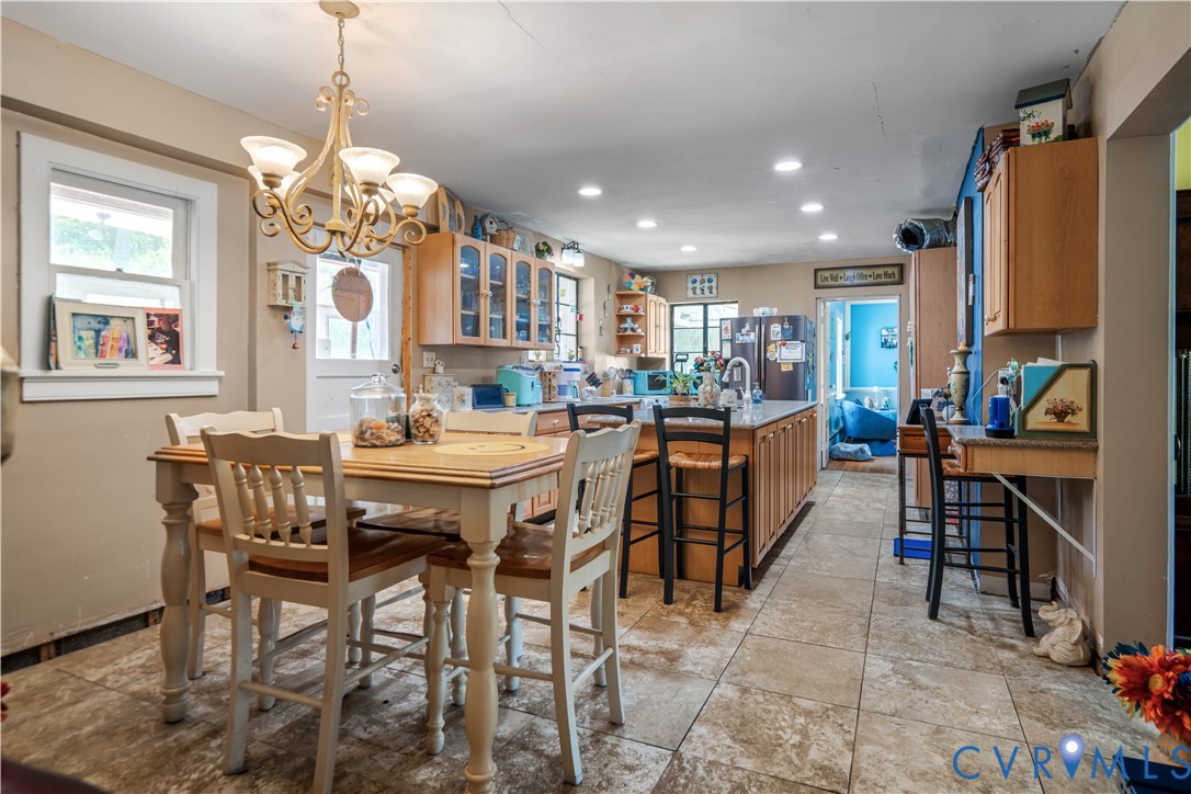 6243 Studley Road Mechanicsville, VA 23116 - Photo 6 of 65 a view of a dining room with furniture and a chandelier