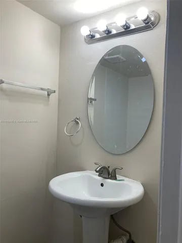 a white toilet sitting next to a bath tub