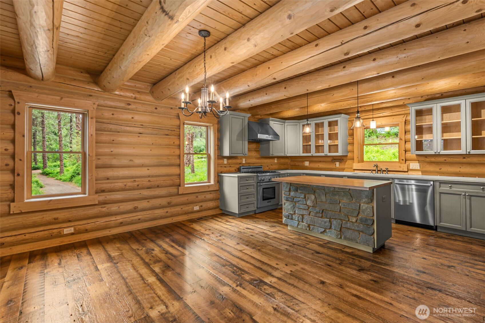 3888 Camas Creek Road Peshastin, WA 98847 - Photo 9 of 40 a large kitchen with a large window a counter space and stainless steel appliances