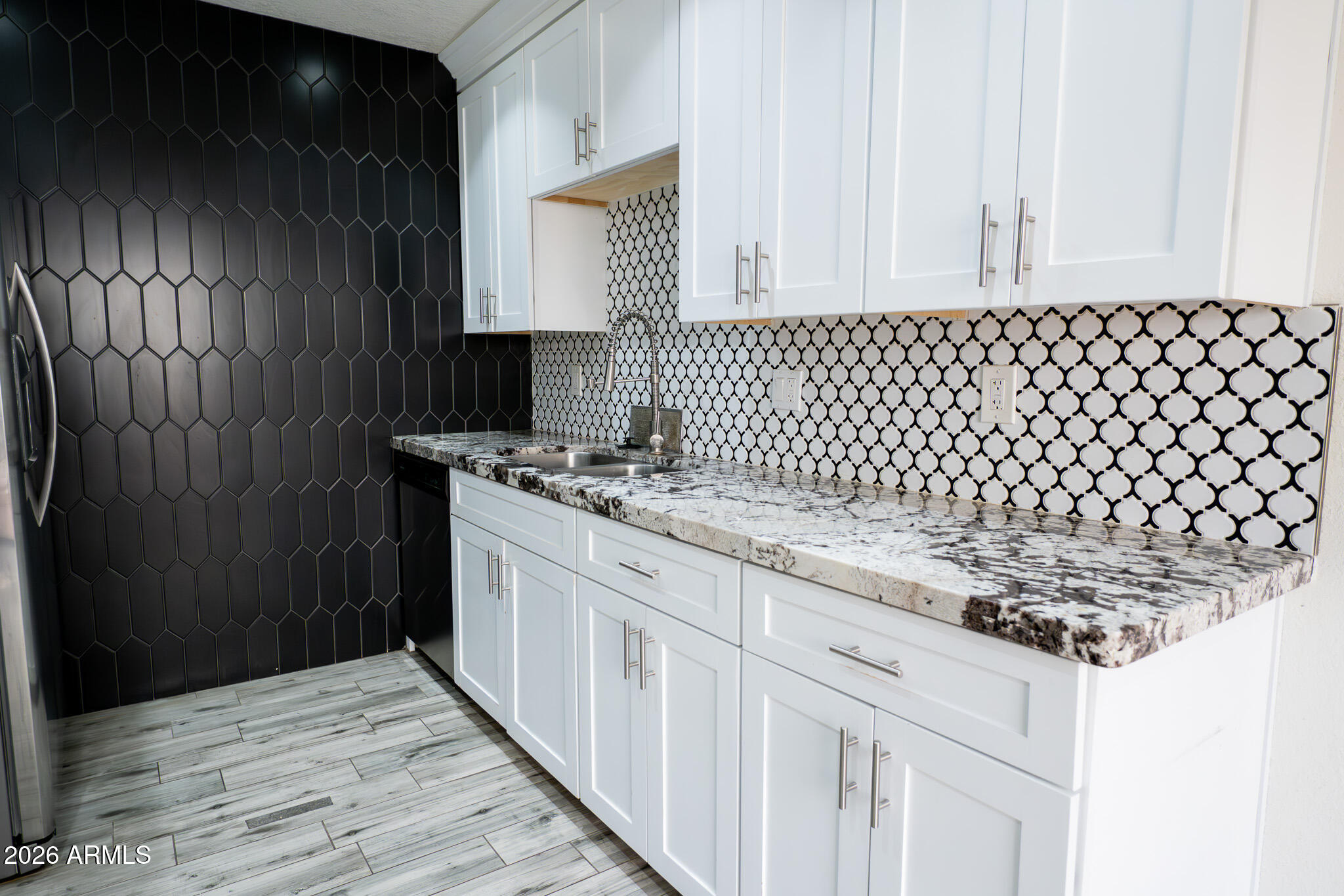 5100 North Miller Road, Unit 3 Scottsdale, AZ 85250 - Photo 10 of 31 a kitchen with granite countertop white cabinets and black appliances
