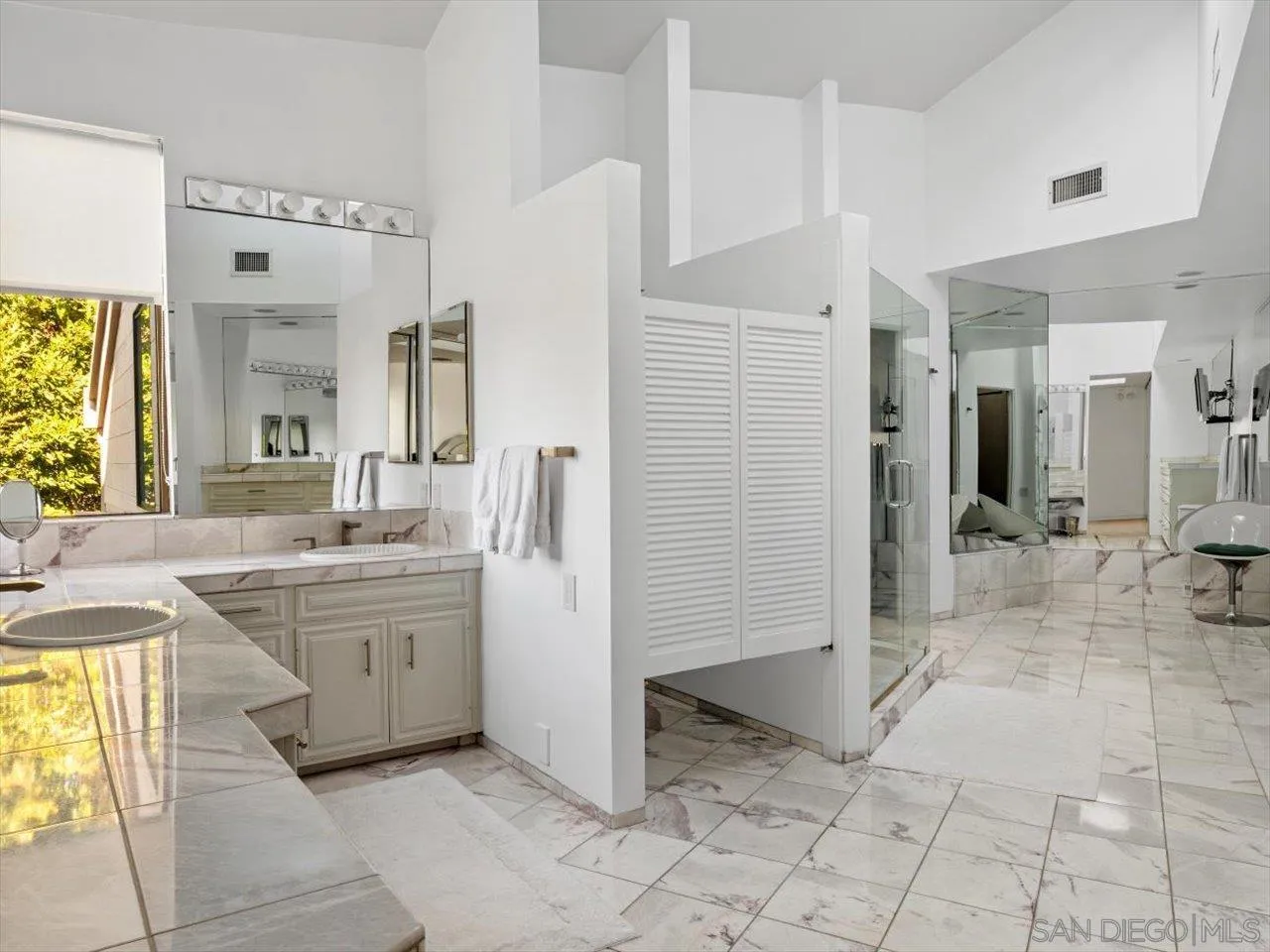 2640 Inyaha Lane La Jolla, CA 92037 - Photo 19 of 25 a bathroom with a granite countertop sink mirror and shower