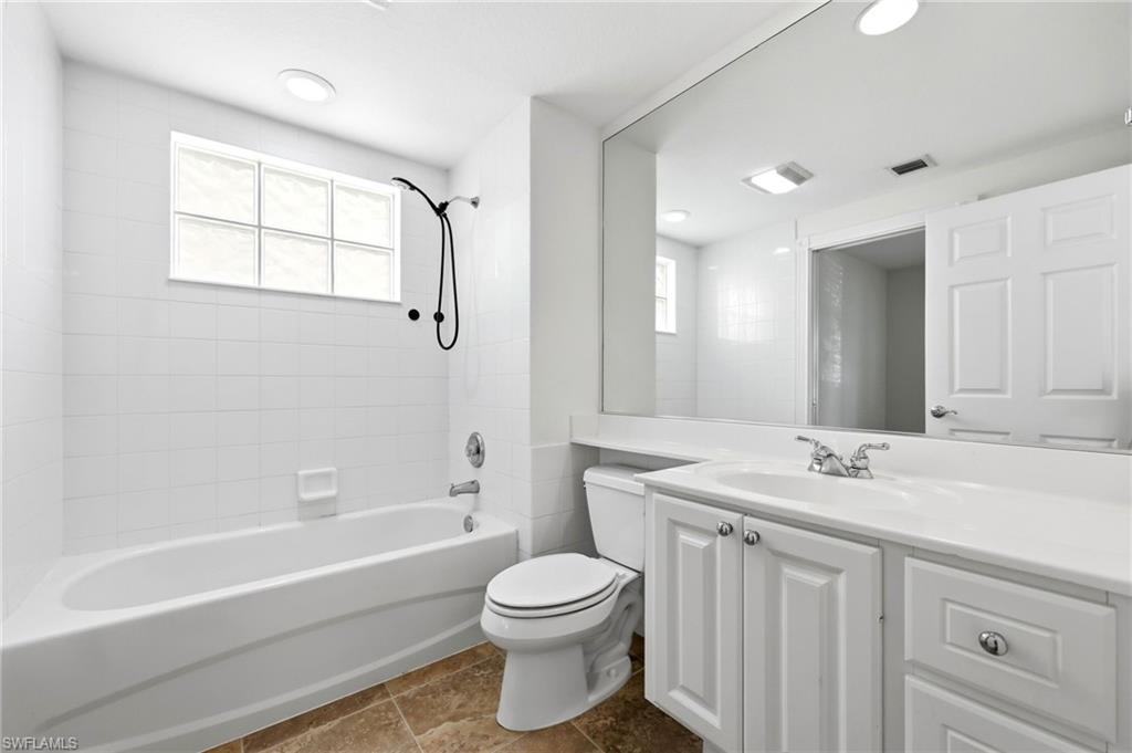 8108 Josefa Way Naples, FL 34114 - Photo 12 of 49 Full bath featuring vanity, bathtub / shower combination, healthy amount of natural light, and dark tile patterned floors