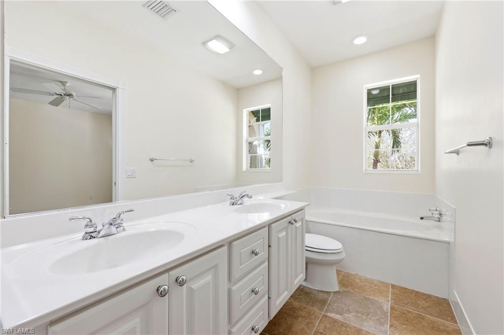 8108 Josefa Way Naples, FL 34114 - Photo 10 of 49 Full bathroom with double vanity and a bath