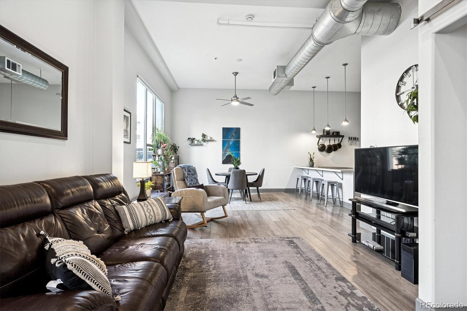 1521 Central Street, Unit 1D Denver, CO 80211 - Photo 11 of 27 a living room with furniture a flat screen tv and a fireplace