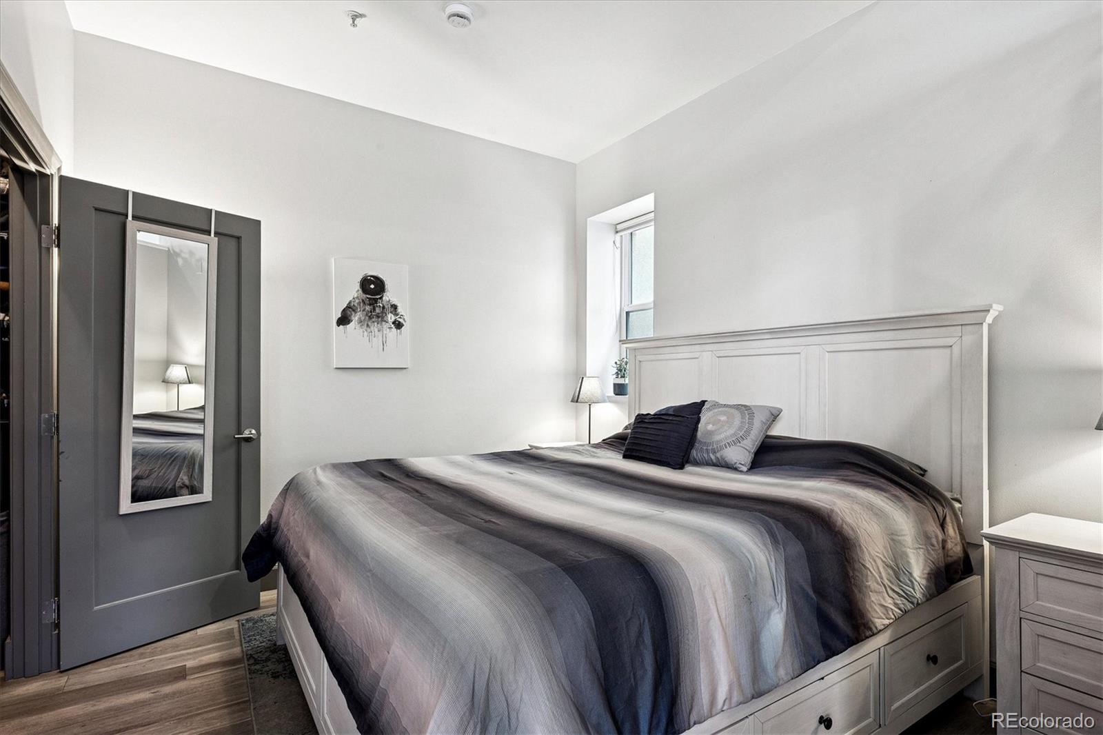 1521 Central Street, Unit 1D Denver, CO 80211 - Photo 15 of 27 a bedroom with a bed and a window