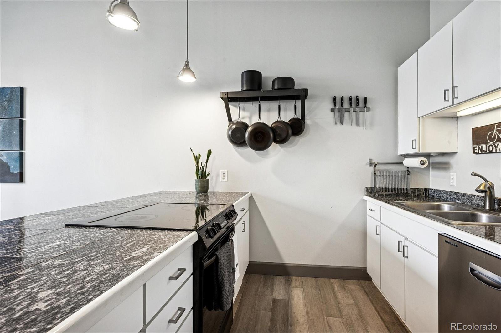 1521 Central Street, Unit 1D Denver, CO 80211 - Photo 5 of 27 a kitchen with granite countertop a sink a stove and refrigerator