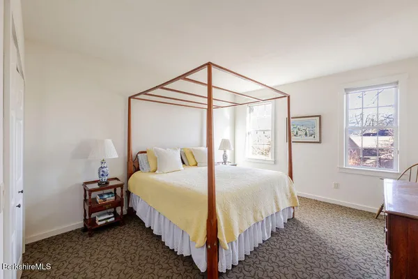 a bedroom with bed and a window