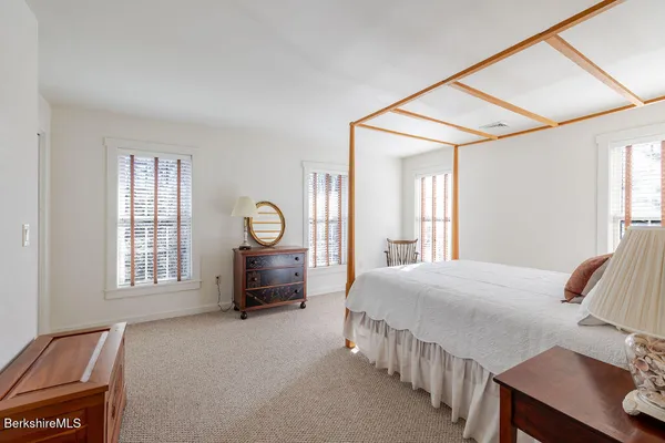 a bedroom with a bed a table and chair