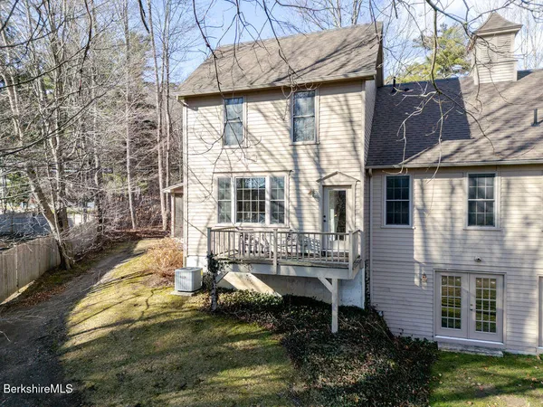 a view of house with backyard and outdoor seating
