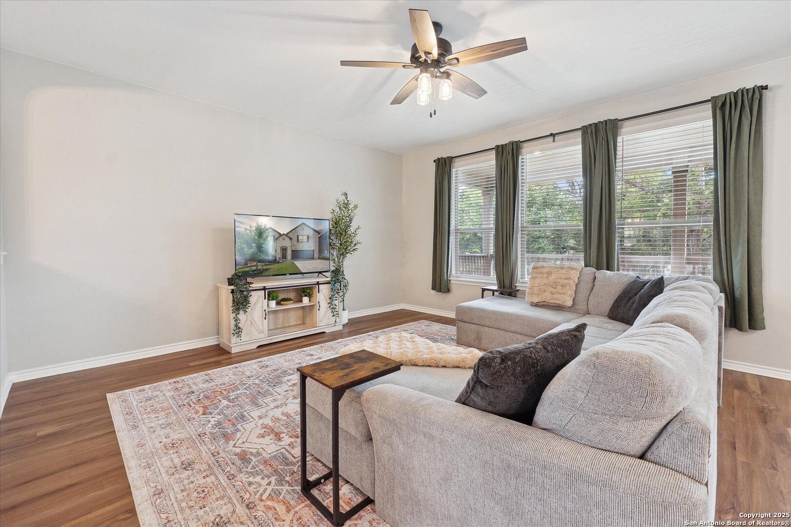 11314 Hill Top Bend Helotes, TX 78023 - Photo 11 of 49 a living room with furniture and a large window