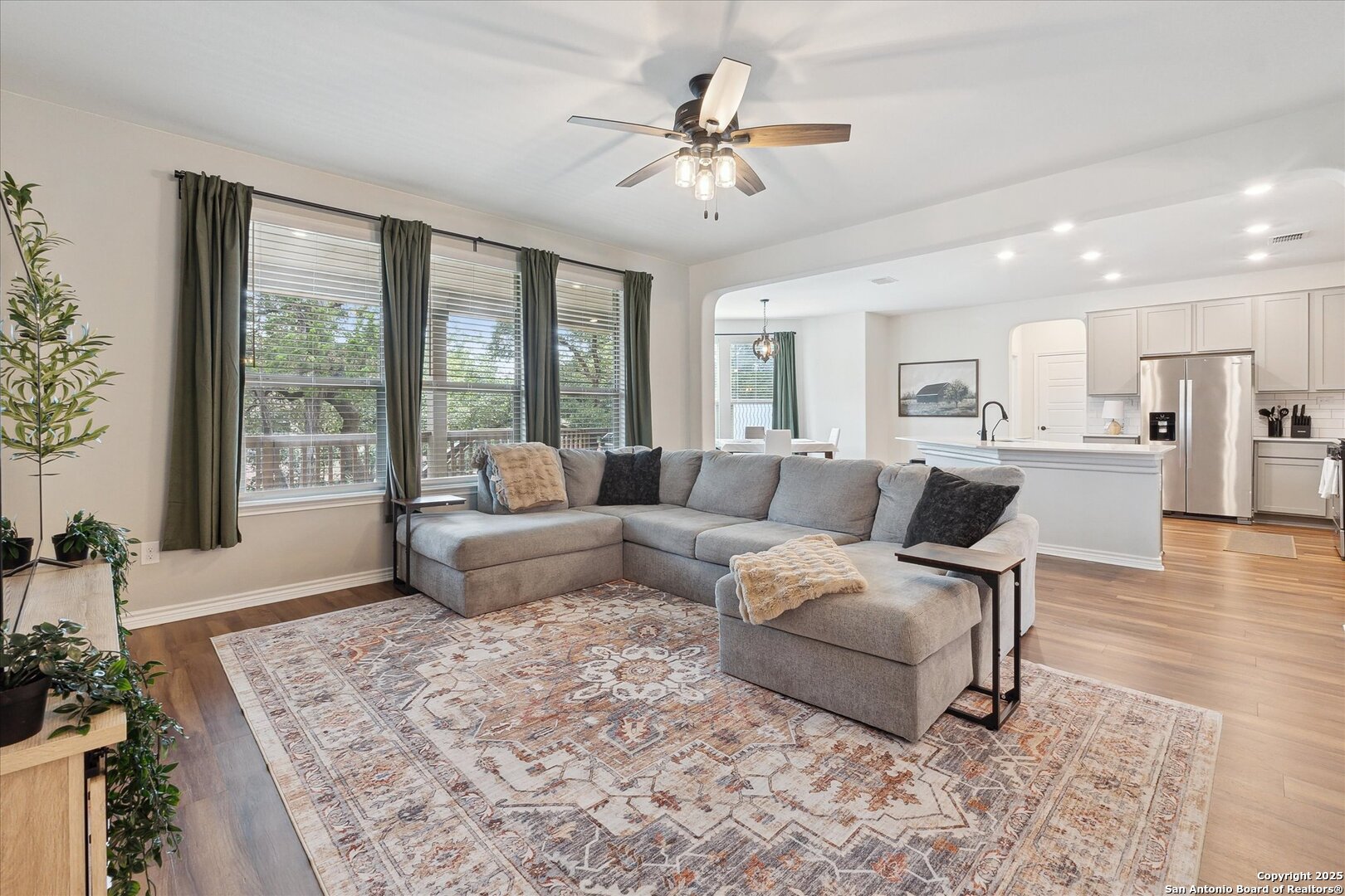 11314 Hill Top Bend Helotes, TX 78023 - Photo 12 of 49 a living room with furniture and a large window with garden view