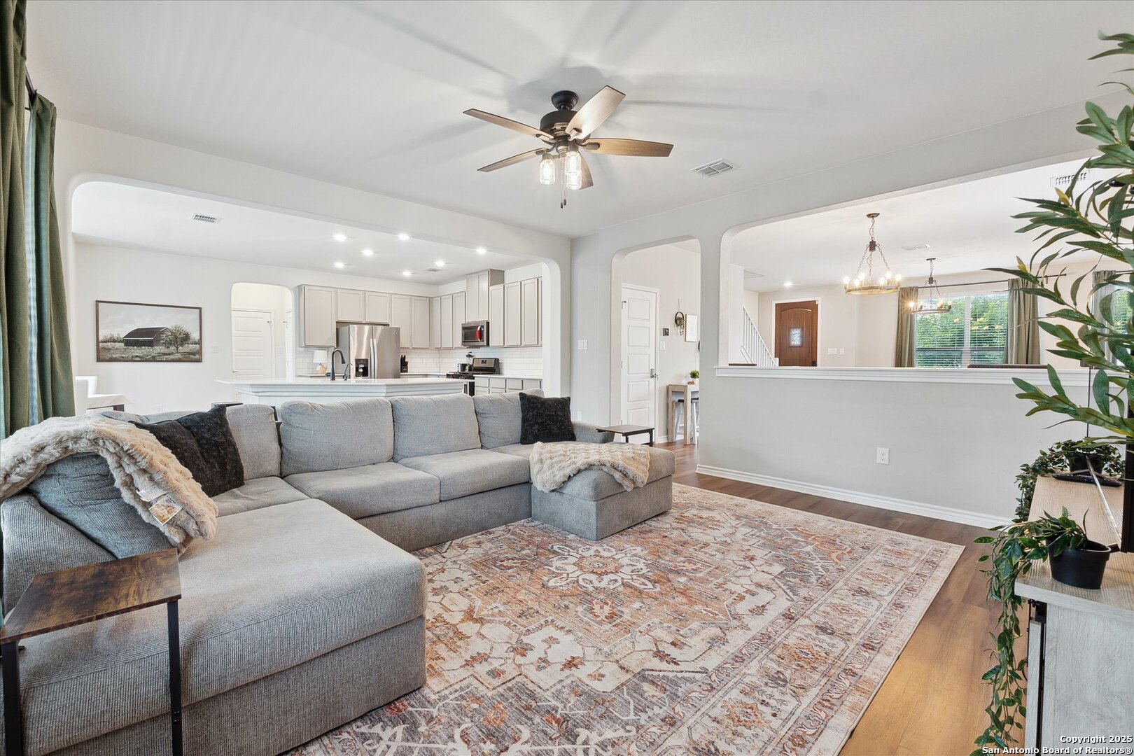 11314 Hill Top Bend Helotes, TX 78023 - Photo 13 of 49 a living room with furniture and a chandelier