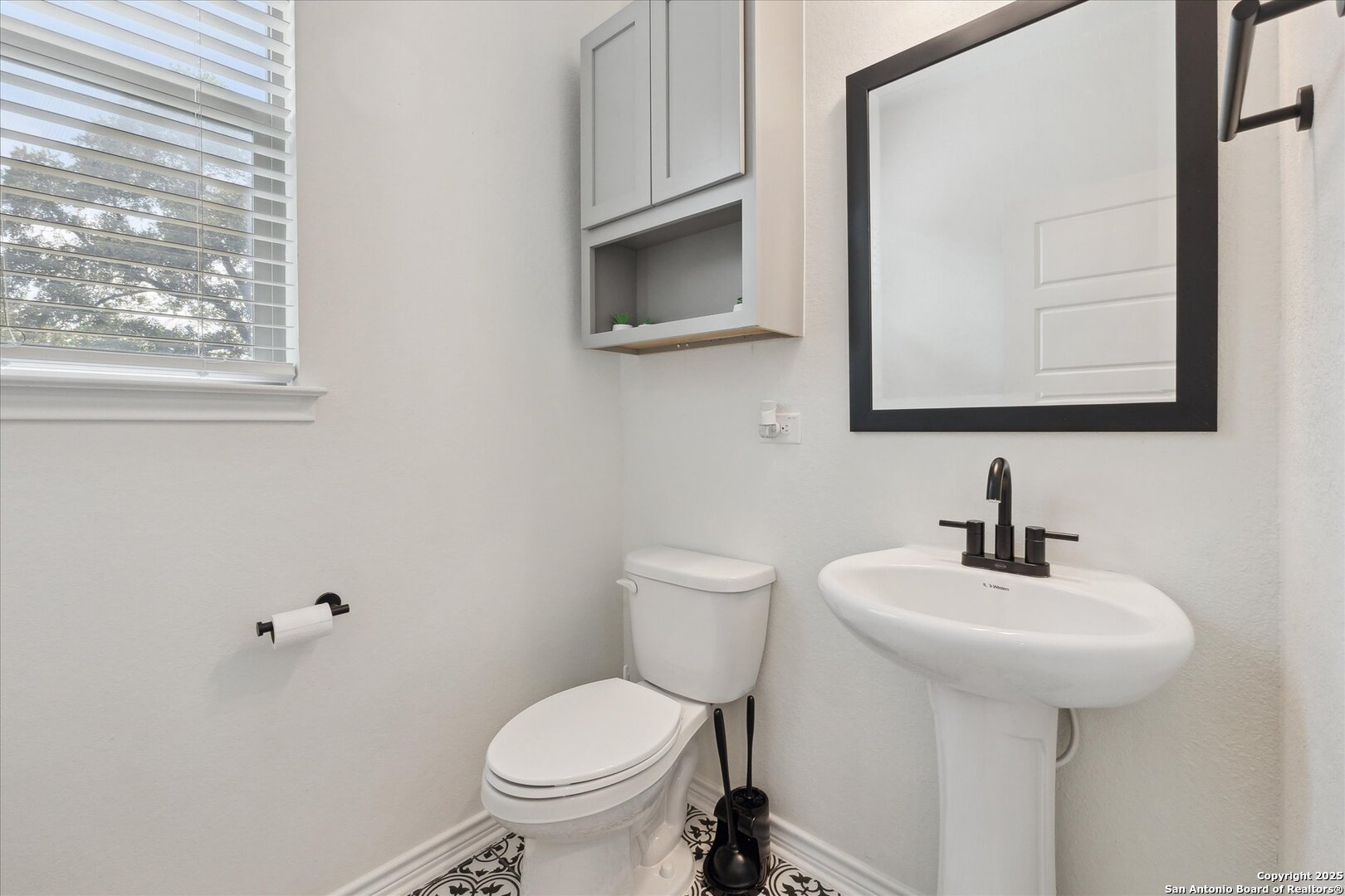 11314 Hill Top Bend Helotes, TX 78023 - Photo 16 of 49 a bathroom with a toilet sink and mirror