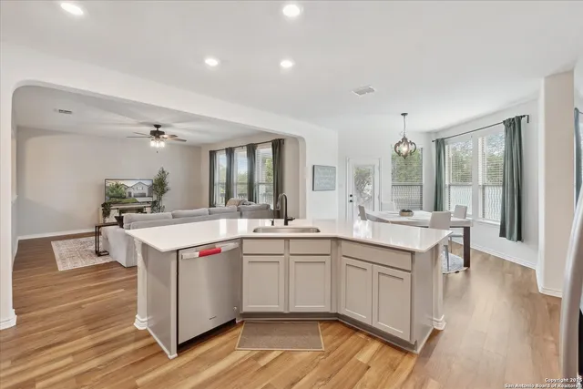 a kitchen with a sink and wooden floor