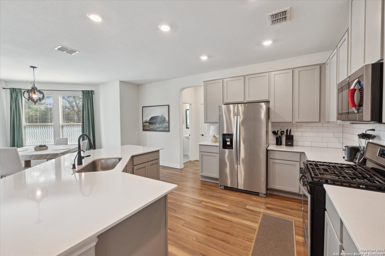 11314 Hill Top Bend Helotes, TX 78023 - Photo 22 of 49 a kitchen with refrigerator and stove
