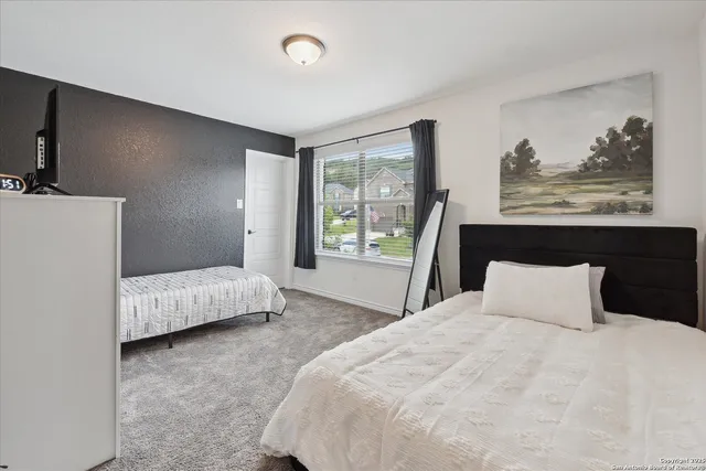 a bedroom with a bed and glass window