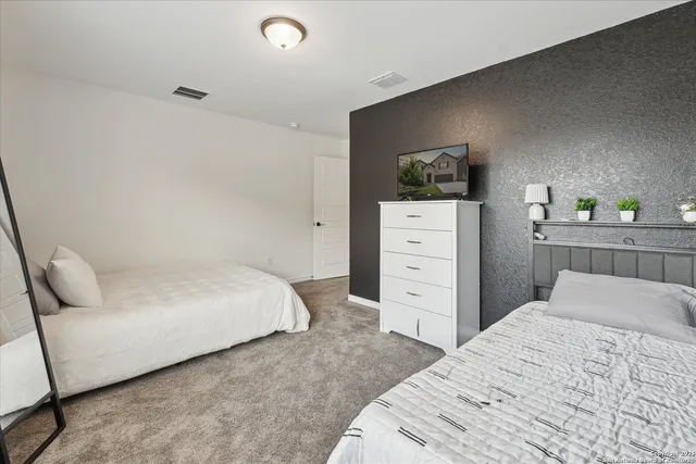 a bedroom with a bed and a dresser