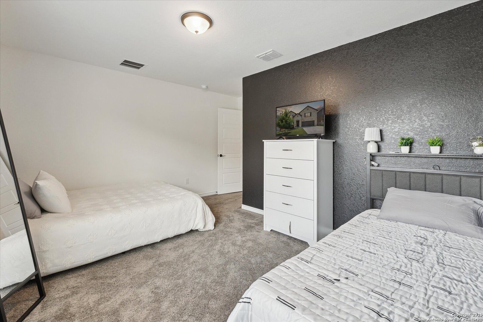 11314 Hill Top Bend Helotes, TX 78023 - Photo 28 of 49 a bedroom with a bed and a dresser