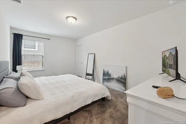 a bedroom with a bed and window