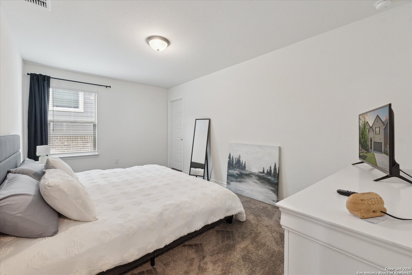 11314 Hill Top Bend Helotes, TX 78023 - Photo 29 of 49 a bedroom with a bed and window