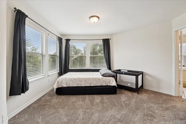 a bedroom with a bed and a night stand