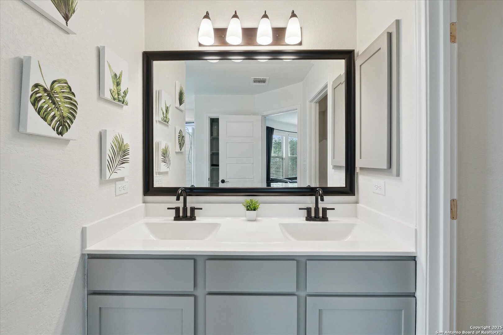 11314 Hill Top Bend Helotes, TX 78023 - Photo 38 of 49 a bathroom with a sink and a mirror