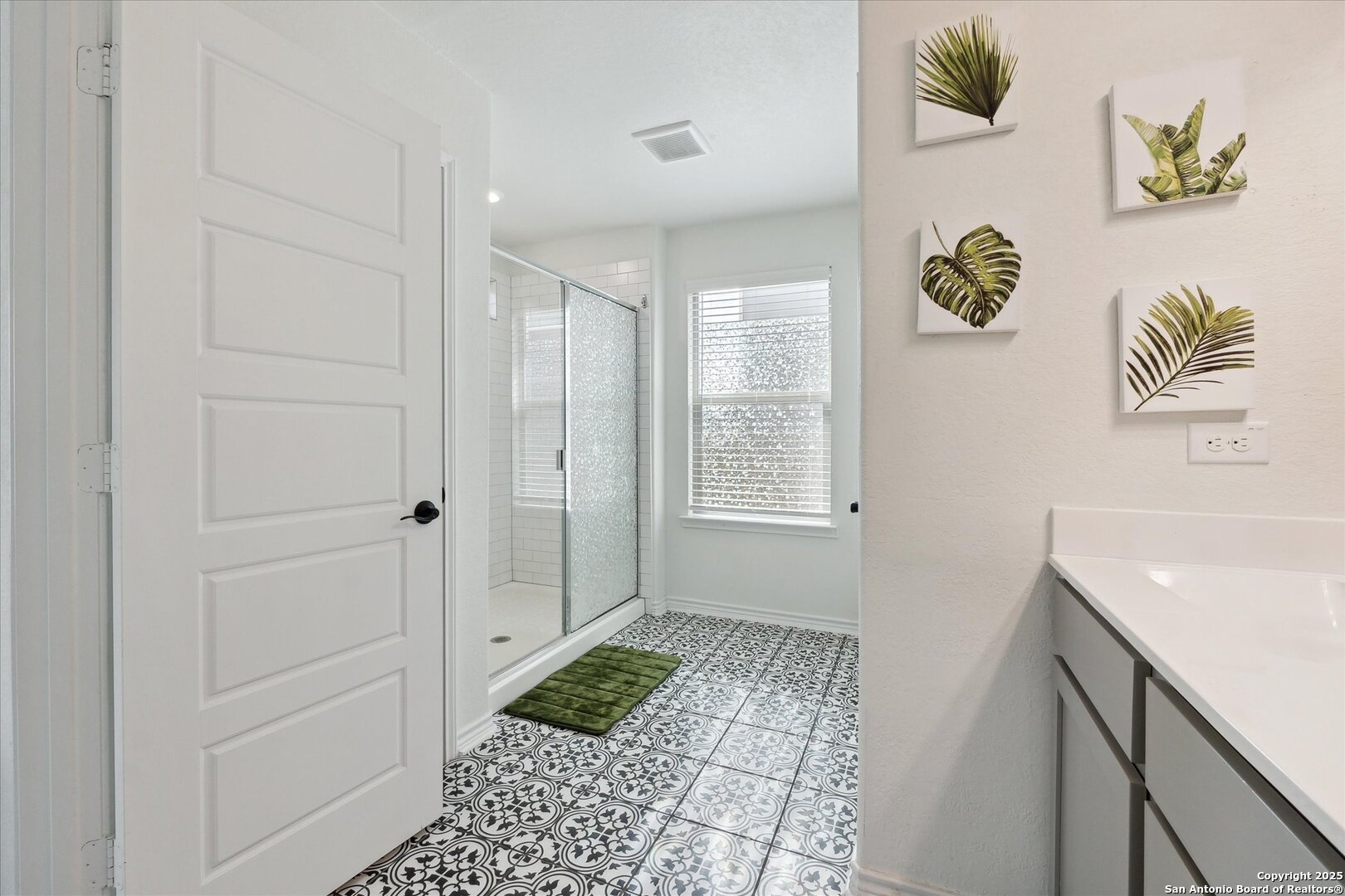 11314 Hill Top Bend Helotes, TX 78023 - Photo 41 of 49 a bathroom with a sink a mirror and a shower