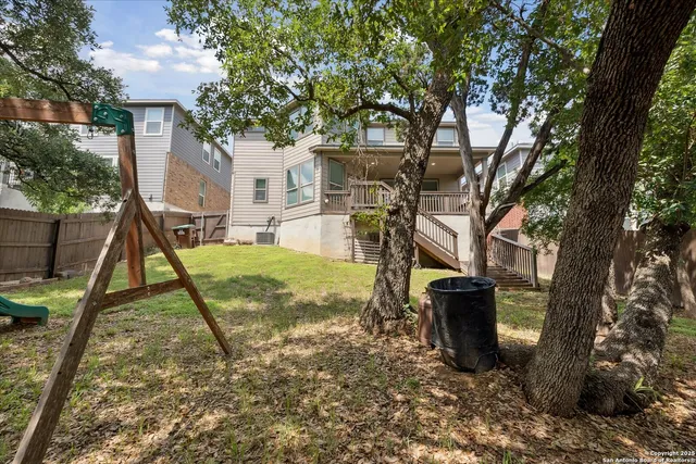 a view of a backyard with a tree