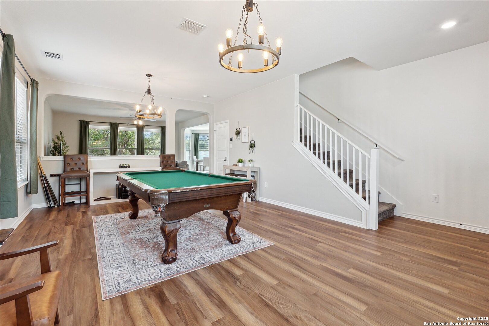 11314 Hill Top Bend Helotes, TX 78023 - Photo 8 of 49 a room with lots of furniture and wooden floor