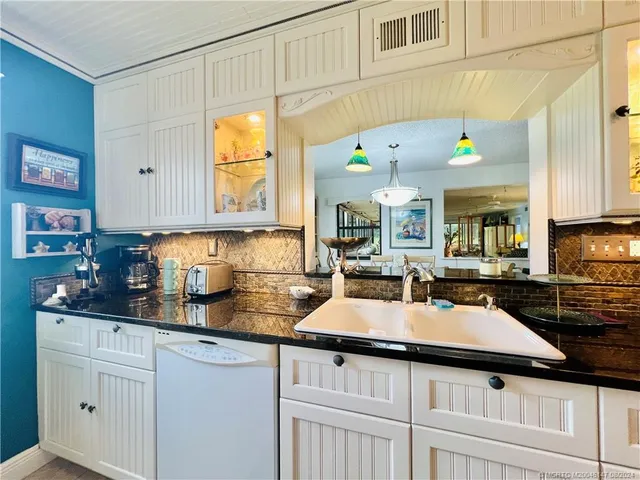 a living room with furniture a flat screen tv and a flat screen tv