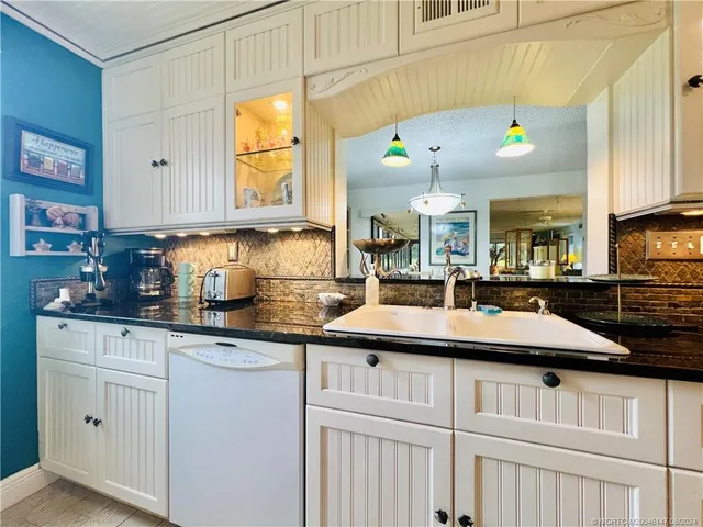 a living room with furniture a rug and a large window