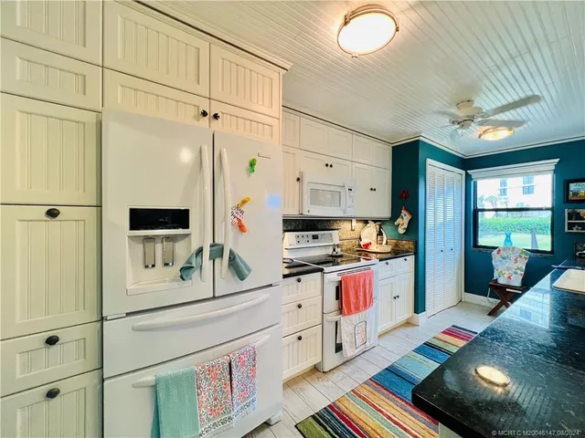 a kitchen with white cabinets and a stove