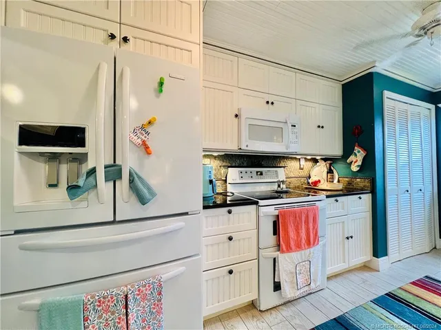 a kitchen with a sink cabinets and window