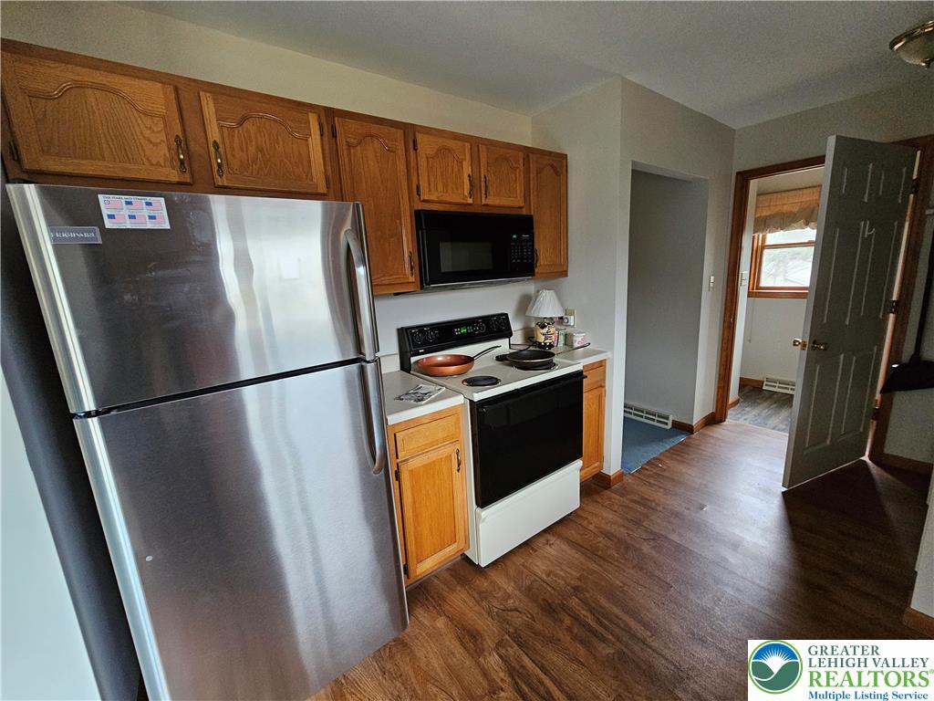 5817 Werleys Corner Road, Unit B New Tripoli, PA 18066 - Photo 8 of 16 a kitchen with stainless steel appliances a refrigerator stove and microwave