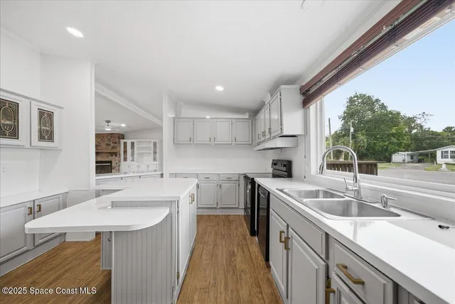 a kitchen with a sink stove and cabinets