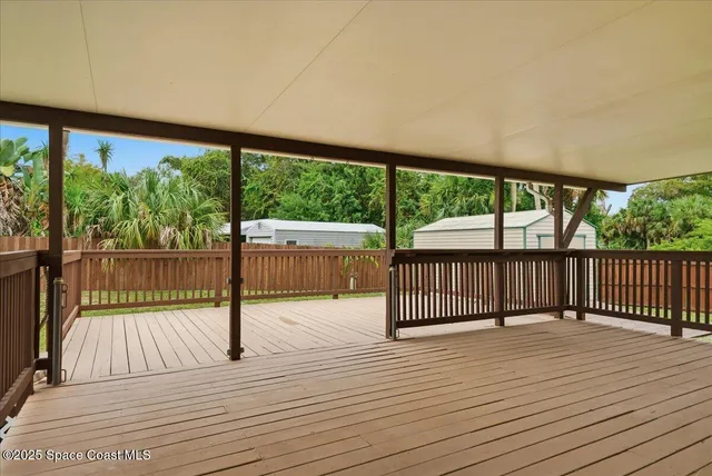 a view of a balcony with wooden floor